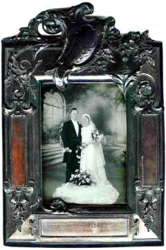 Mirror ? Currently holds a photo, but has the typical heavy wooden back of a bedside Mirror. Has wood veneer inserts at 3 o/c, 6 o/c and 9 o/c.