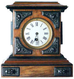 Clock. This clock has Bois Durci sections at each corner, and small plaques on the base.