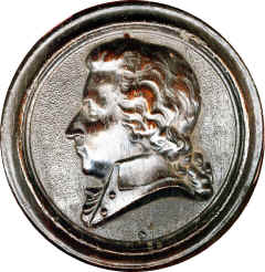 Same portrait as Bois Durci but made in a Papier Mache like material covered ina thin wood veneer and varnished. No engravers mark. Design recessed on back.